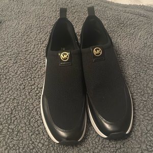 Like New women’s 11 Michael Kors black slip on sneakers with gold accents